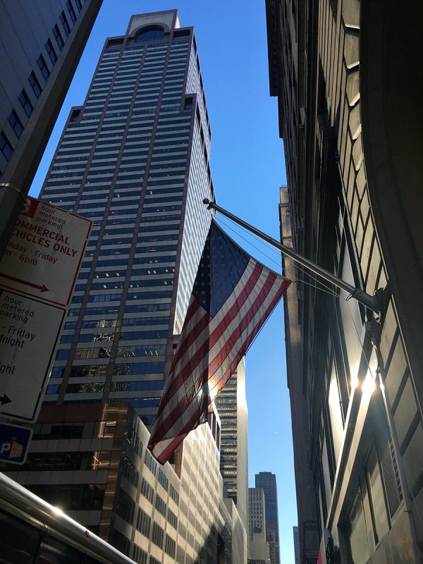 Strahlende Morgensonne auf einer amerikanischen Flagge beim Rockefeller Center in New York City.